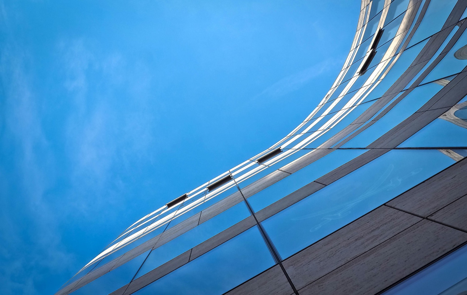 Glass and steel architecture against a blue sky